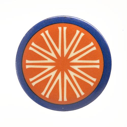 Round red badge with thin blue border. Star shaped pattern.
