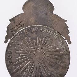Back of round silver medal has cloth cap of liberty omitting sun rays.  Loop at top.