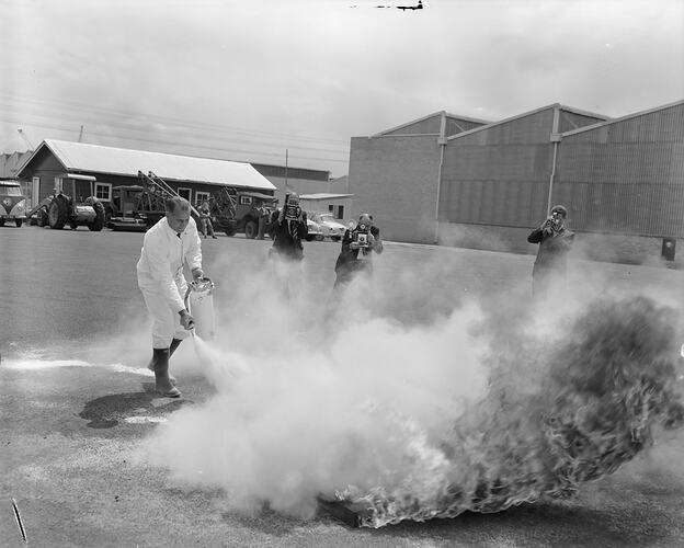 Man Using a Fire Extinguisher, Fishermen's Bend, Victoria, Nov 1958