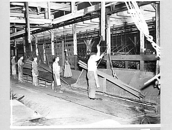 Six production line workers in factory.