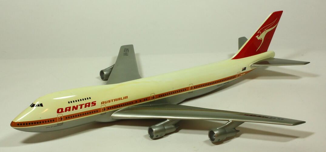 White model plane with red trim and tail. Grey wings. Left front three quarter view.