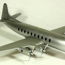 Silver model aeroplane with two propellers on each wing.