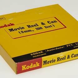 Yellow rectangular box with black, red and yellow printing.