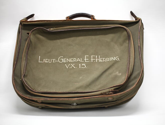 Front of khaki canvas valise (bag) with name Herring.