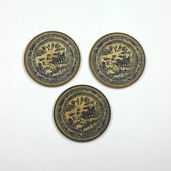 Three identical patterned paper plates.