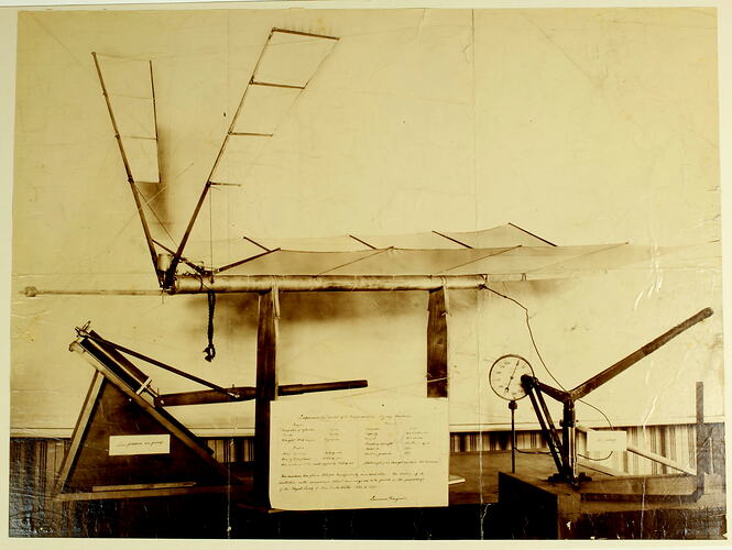 Model airplane on bench with information sheet in front.