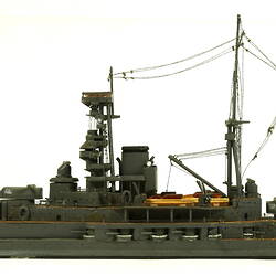 Naval ship with mast, facing left.