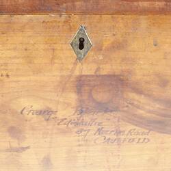 Detail of wooden box, showing inscription.