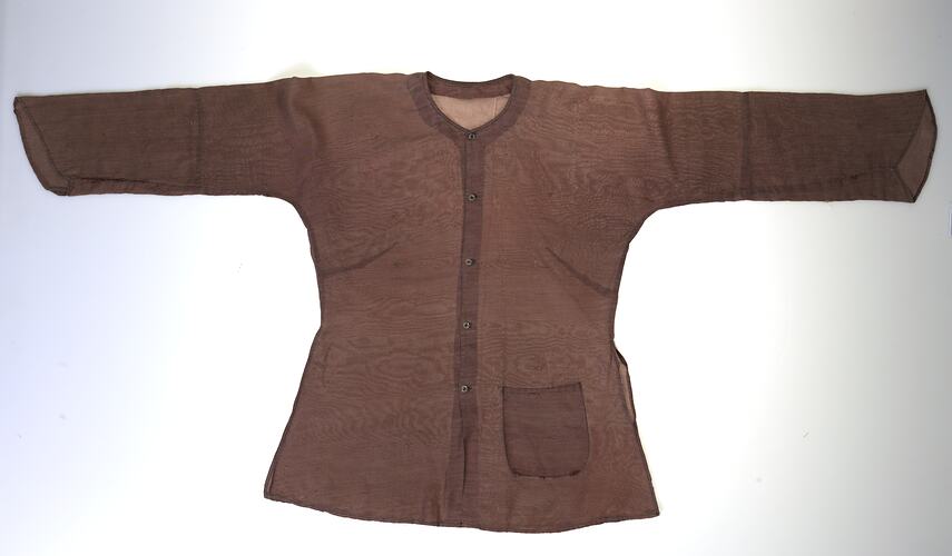 Brown collarless long sleeve button up shirt. Hip pocket at left.