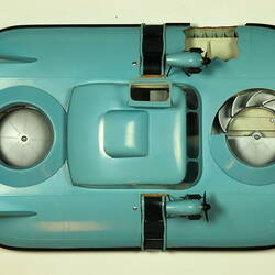 Light blue hovercraft with two propellers, overhead view.