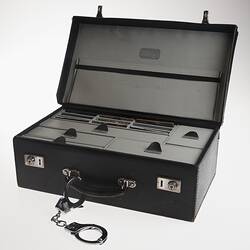 Black leather briefcase. Open showing internal drawers.