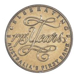 Round gold medal with decorative cursive text in centre. Text around edge.
