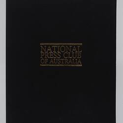Closed black menu folder with gold lettering.