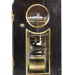 Side view of a clock in a balck and gold case.