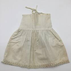 White doll's petticoat with shoestring straps.