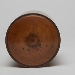 Top view of lid on cylindrical wooden box.