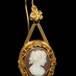 Gold mounted cameo earrings. Round white cameo profile bust with brown background, gold border.