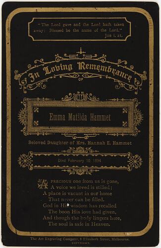 Black card with gold lettering and decorative borders.