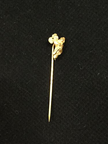 Gold stick pin with a small irregular gold nugget at the end.