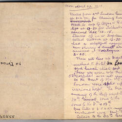 Open book with blank page on left and blue handwritten text on right.
