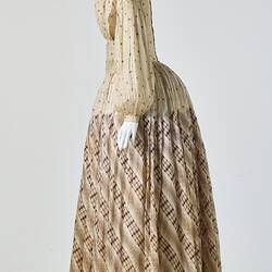 Cream muslin dress, high neck, long sleeves, banded waist, full length gathered skirt. Bustle. Profile.