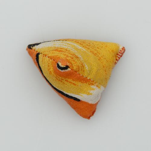 Triangular fabric jack. Yellow, white, orange and black pattern.