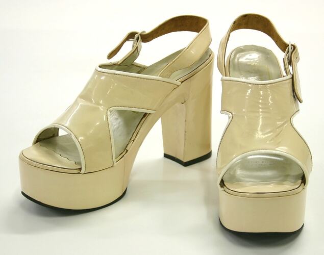 Cream patent leather platform sandals.
