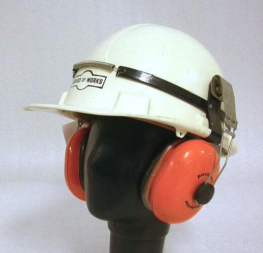 White hard hat with ear-muffs attached.