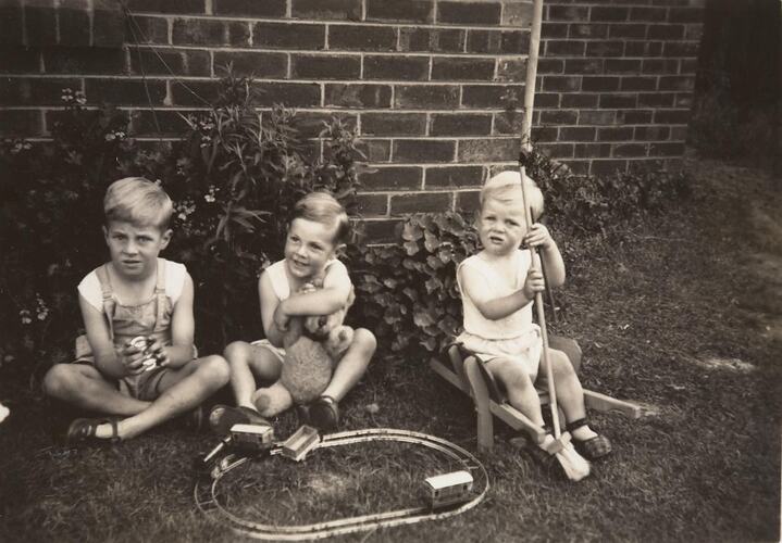 Digital Photograph - Three Boys with Train Set & Teddy, Backyard, Strathmore, 1949