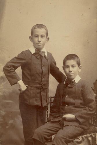 Digital Photograph - Two Boys in Suits, One Seated in Wooden Chair, One Standing, Collingwood, circa 1900