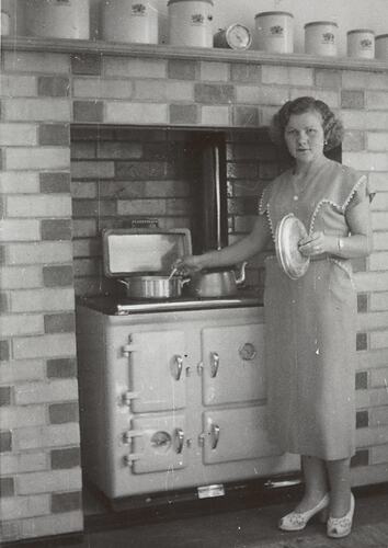 Digital Photograph - Woman with New Wood burning Stove, Kitchen, circa 1955
