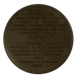 Round medal with text in relief.