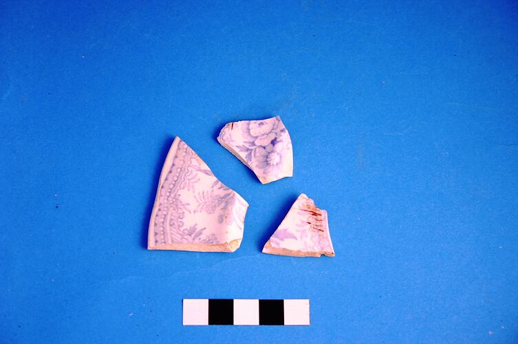 Three pieces of broken ceramic plate.