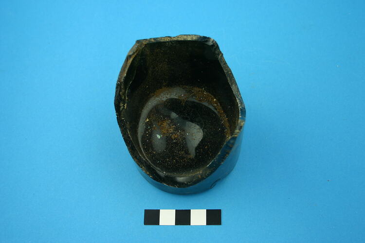 One glass bottle base, dark green.