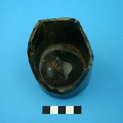 One glass bottle base, dark green.