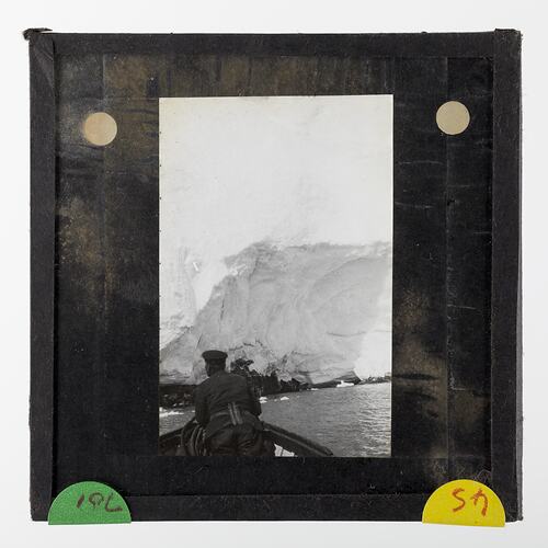 Lantern Slide - Explorer at the Bow of the Discovery's Motor Boat, BANZARE Voyage 2, Antarctica, 1930-1931