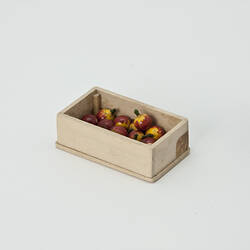 Wooden box containing apples.