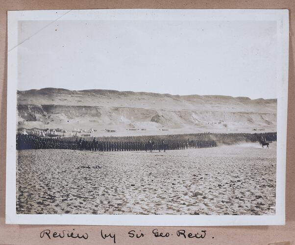 Large group of soldiers standing in formation, handwritten text below.