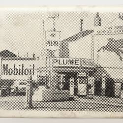 White matchbox cover with black printed image of service station.