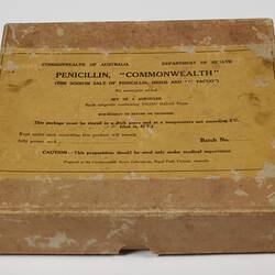 Brown cardboard box with yellow printed label. Contains five hand-blown cylindrical glass ampoules.
