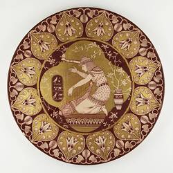 Plate - Ceramic, Egyptian Style Harpist, Red Glazed With Gilt, Signed 'GMS', 1888