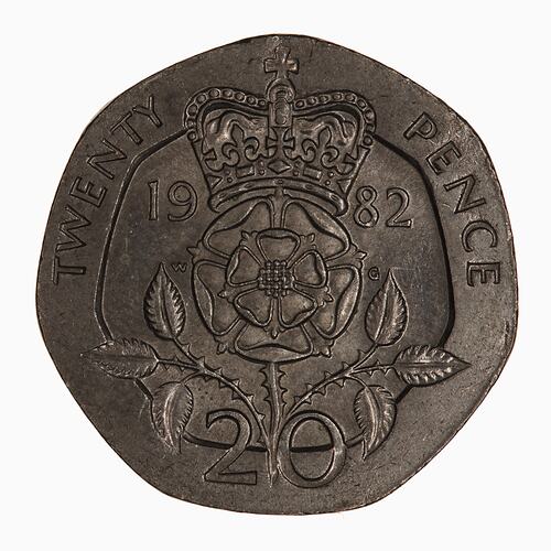 Seven-sided coin with rose and two thorny branches, text around. Crown atop rose.