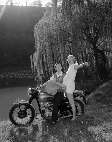 Pacific Magazines Pty Ltd, Two Models on a Triumph Motor Cycle for New Idea Magazine, Black Rock, Victoria, Sep 1954