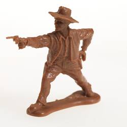 Brown plastic cowboy pointing a gun.