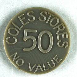 Grey plastic circular disc, printed on each side; 'COLES STORES 50 NO VALUE'.