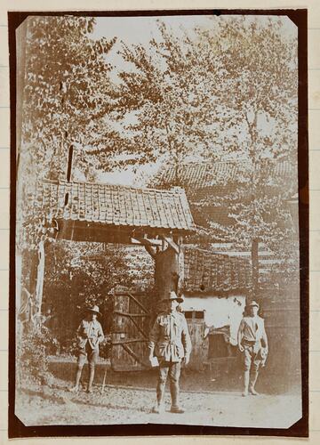 Soldiers standing near front gates.