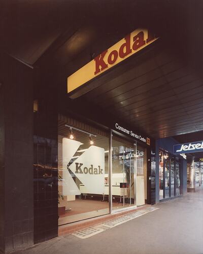 Footpath and glass door to Kodak shop.