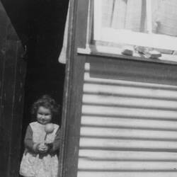 Digital Photograph - Shirley Forbes Standing in Doorway of Her House, Broadmeadows Migrant Hostel, Melbourne,1961