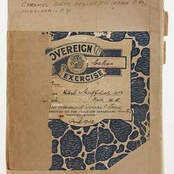 Worn and scuffed blue exercise book cover with label affixed along top.