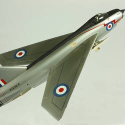 Silver model aeroplane. Blue, white and red rondels on wings and fuselage.